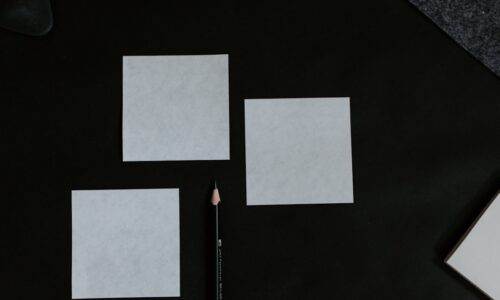 A black table topped with a pencil and paper