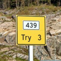 a yellow sign that says try 3 on it