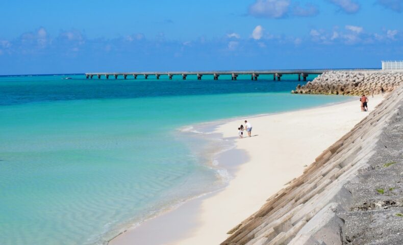 a beach with people walking on it