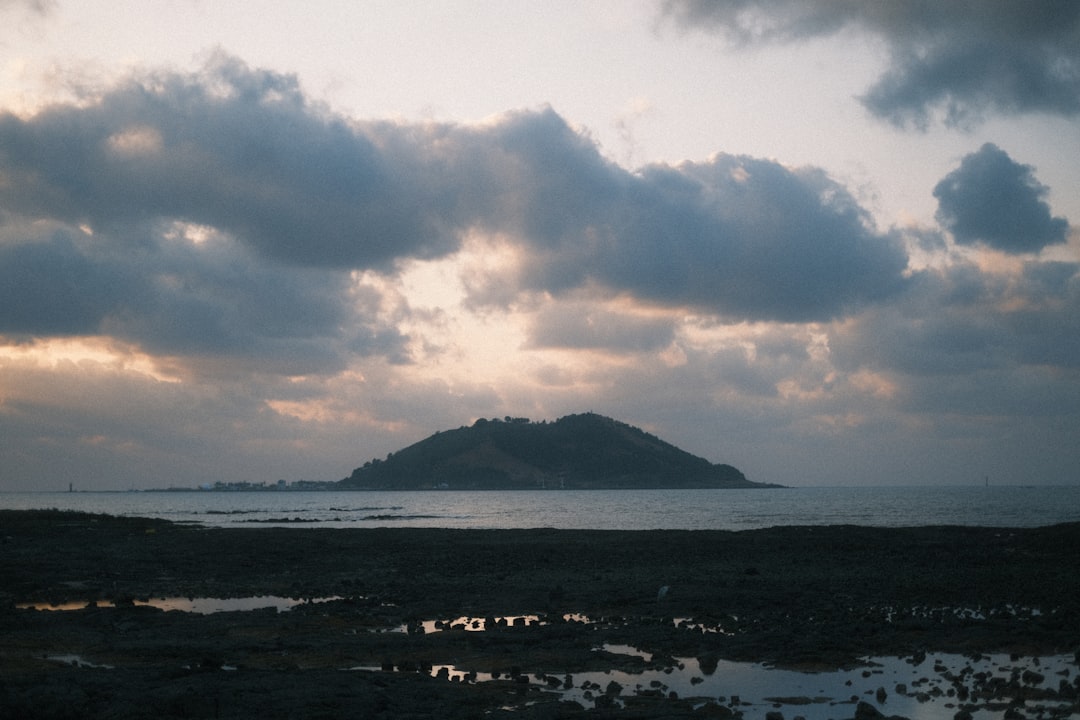 a large body of water with a small island in the distance