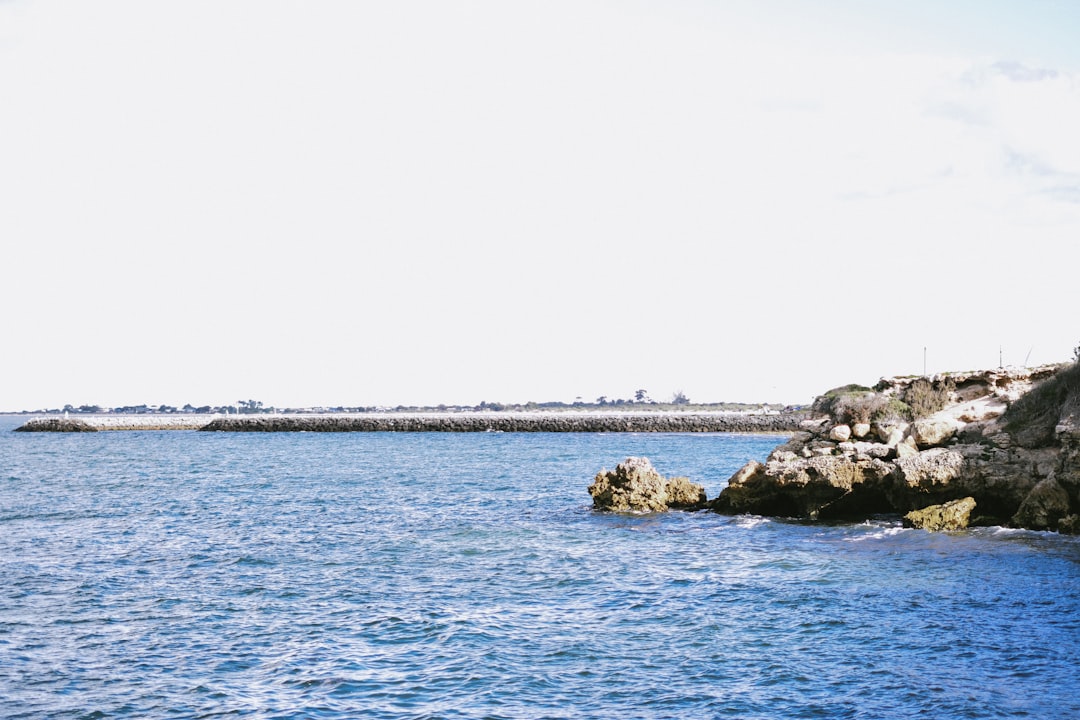 a body of water with rocks in the middle of it