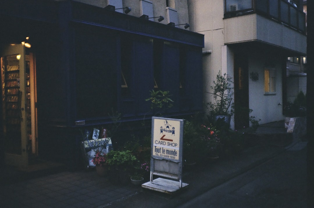 A sign on the side of a building in front of a building
