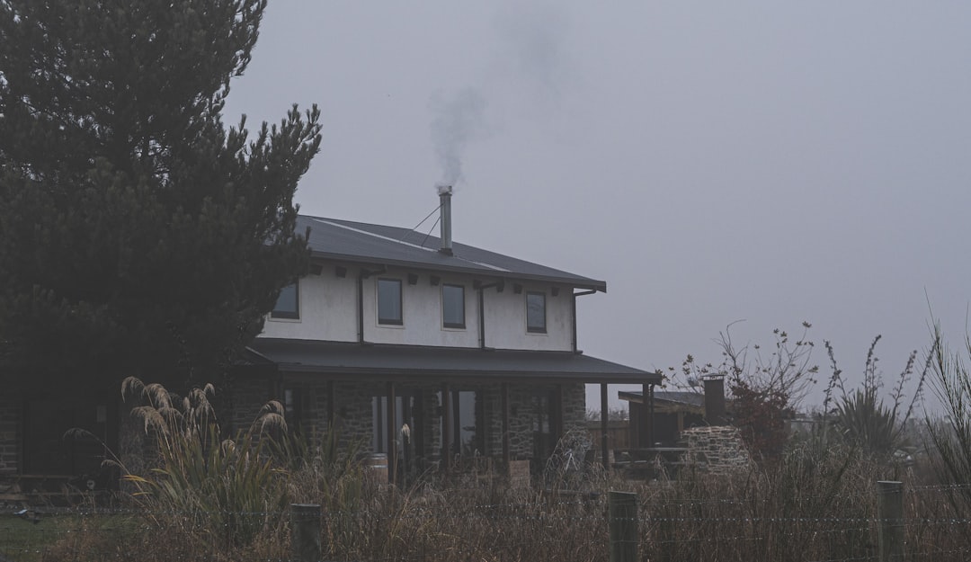 A house with smoke coming out of the chimney