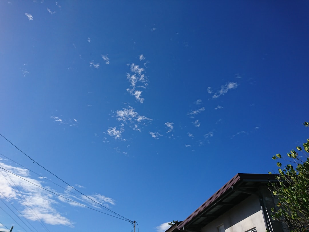 a clear blue sky with some clouds in the background