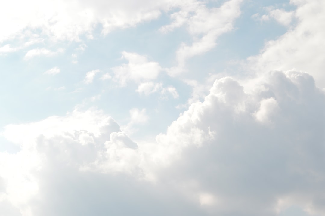 White fluffy clouds float in a blue sky.